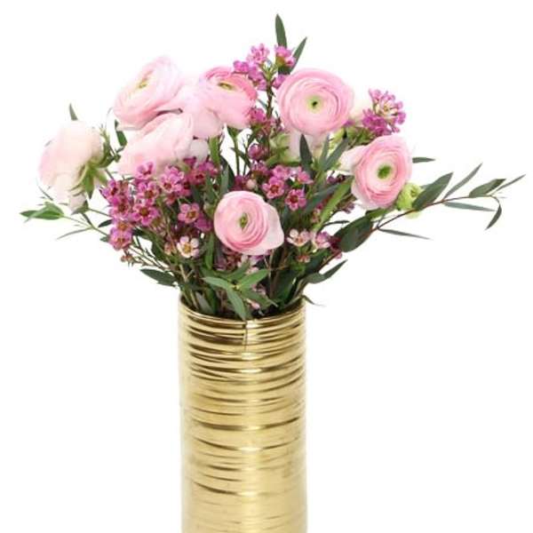 Pink flowers arranged in a gold vase