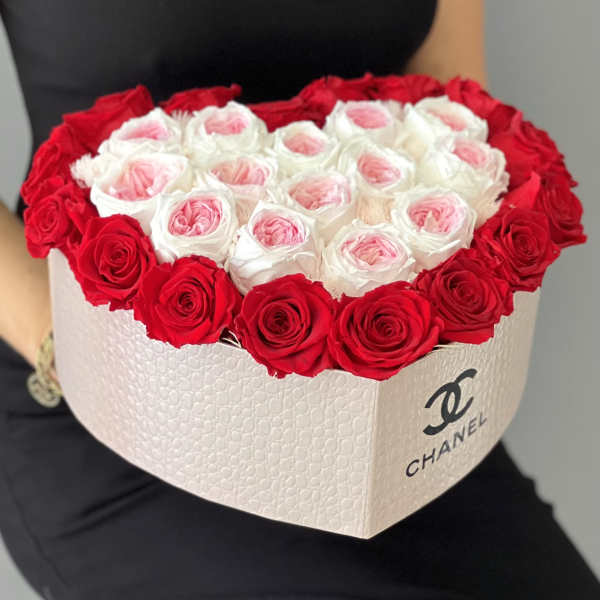 Heart-shaped box of red and white roses with pink centers