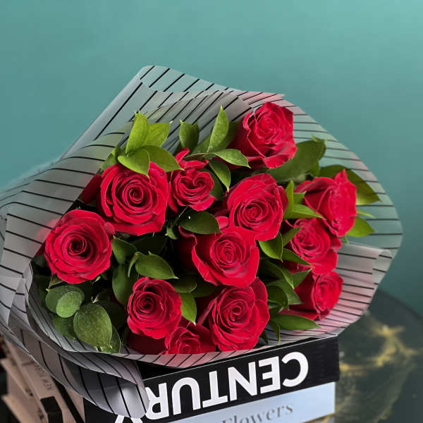 Bouquet of red roses wrapped in striped paper