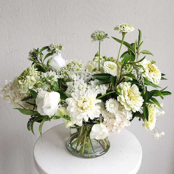 White floral arrangement in a clear glass vase