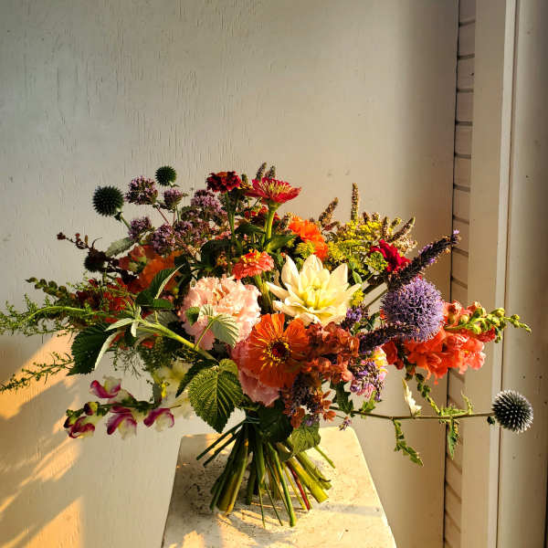 Colorful mixed bouquet with orange, pink, purple, and white flowers