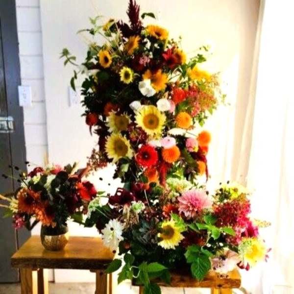 Large colorful floral arrangement with sunflowers and mixed blooms