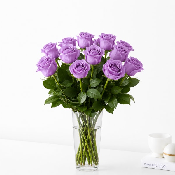 Lavender roses arranged in a clear glass vase