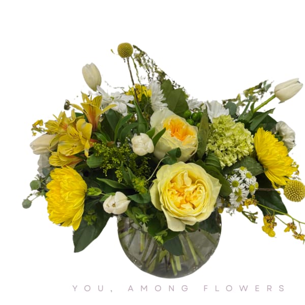 Yellow and white flower arrangement in a glass vase