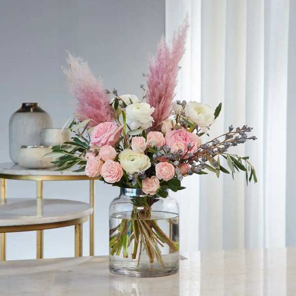 Pink and white bouquet in a clear glass vase