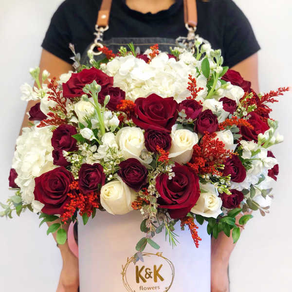 Large bouquet of red and white roses in a white hat box