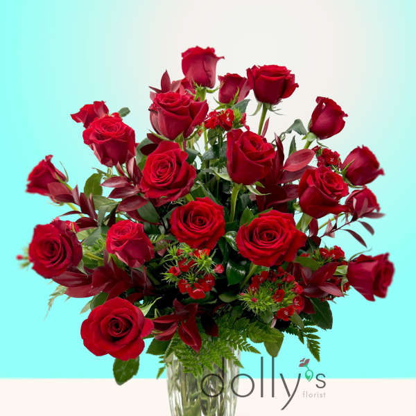 Red roses arranged in a clear glass vase