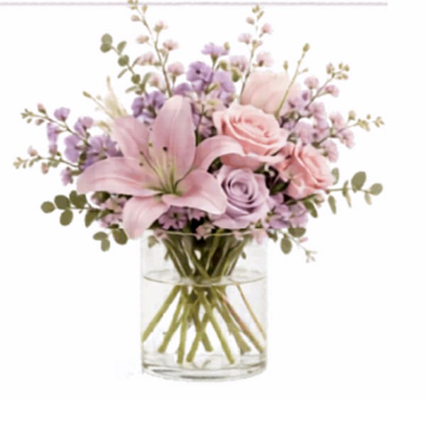 Pink and lavender flowers arranged in a clear glass vase
