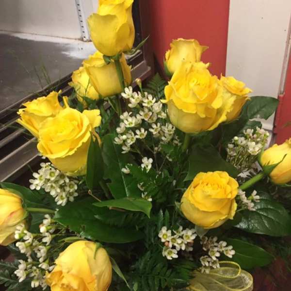 Bouquet of yellow roses with small white filler flowers