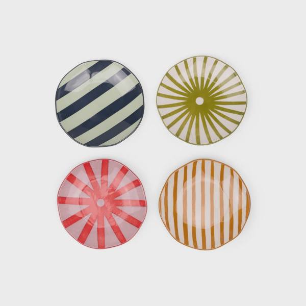 Four round striped decorative plates in navy, green, red, and orange.
