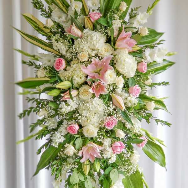 Tall standing floral spray with pink and white lilies and roses