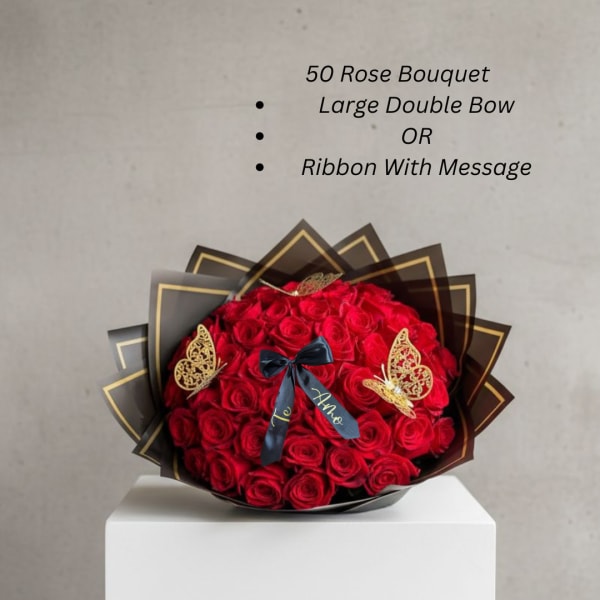 Large bouquet of red roses with a black ribbon and butterfly decorations