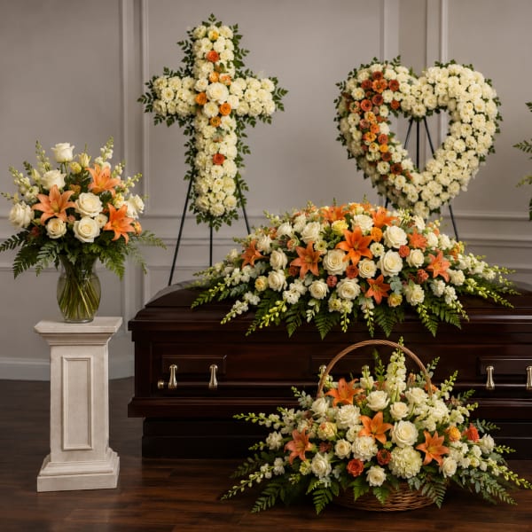 Funeral casket surrounded by white and orange floral sprays and baskets