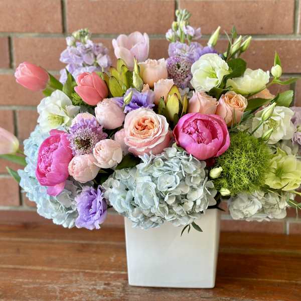 Mixed pastel bouquet in a white square vase