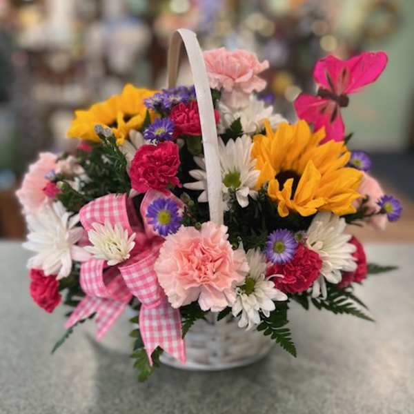 Basket of mixed flowers with a pink gingham ribbon