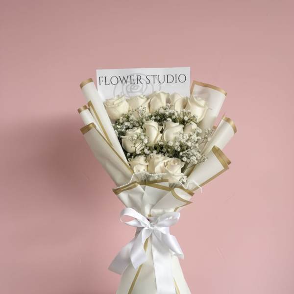 Bouquet of white roses with baby's breath in white and gold wrap