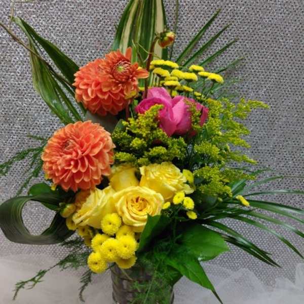 Colorful mixed flower arrangement in a glass vase