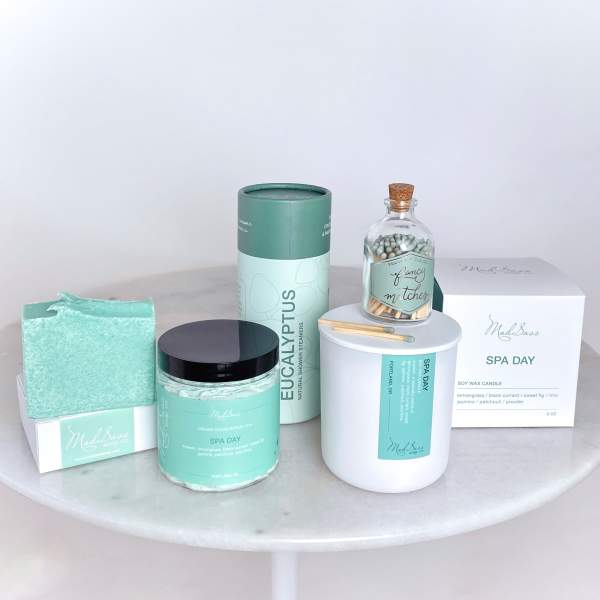 Spa gift set with candles, soap, matches, and bath items in mint packaging