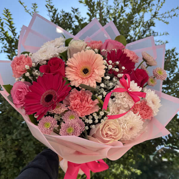 Pink and white mixed bouquet with gerbera daisies, roses, and carnations