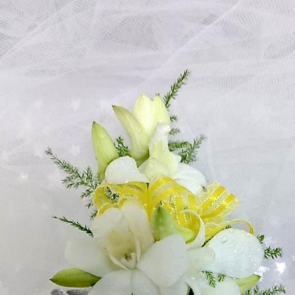 White floral bouquet with yellow ribbon accents on sheer fabric