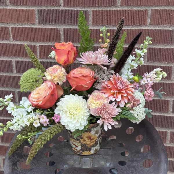 Mixed bouquet in a floral tin container with roses, dahlias, and chrysanthemums