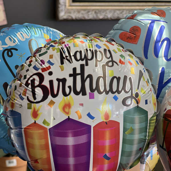Birthday balloons with candles and confetti