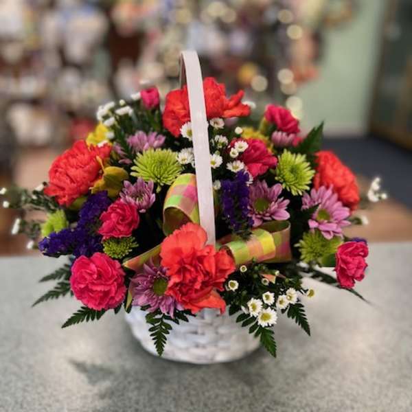 Colorful mixed flower basket with a white handle