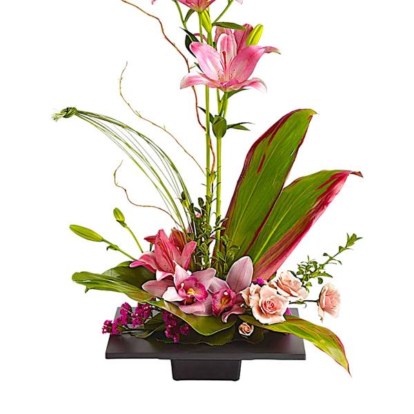 Tall floral arrangement with pink lilies and orchids in a black container