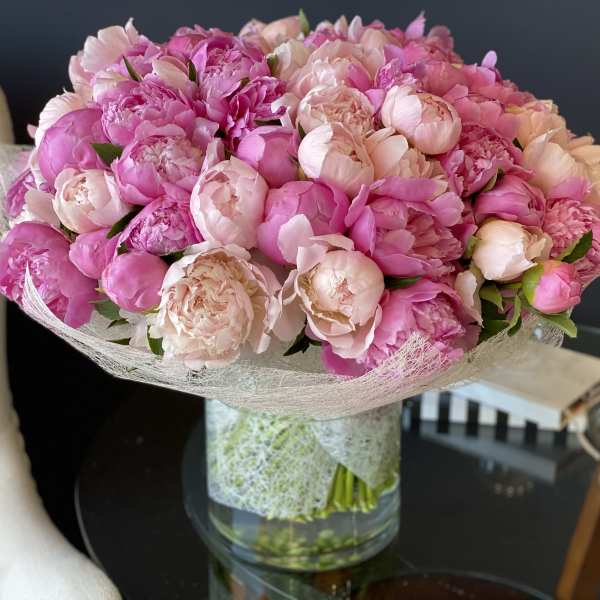 Pink peony bouquet in a clear glass vase