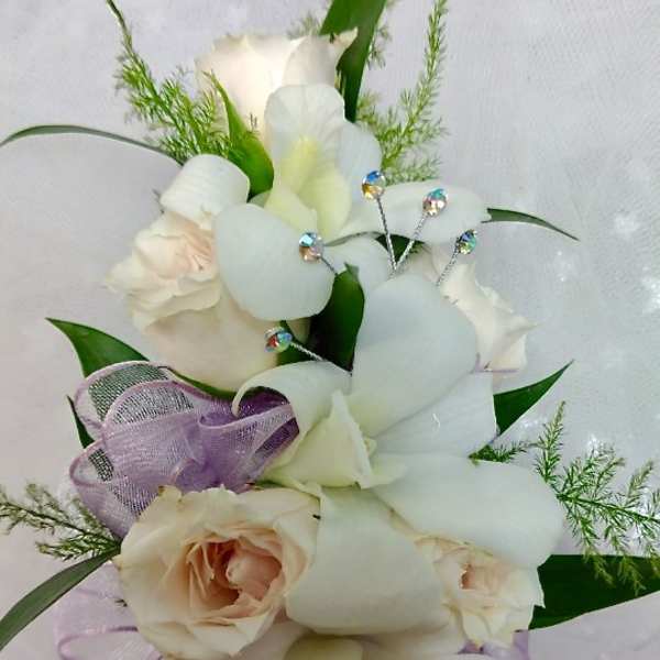 Bouquet of white orchids and pale roses with purple ribbon
