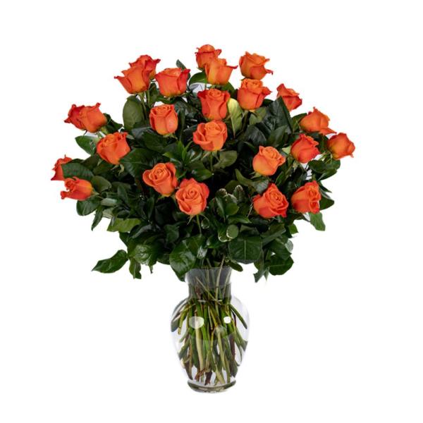 Tall arrangement of bright orange roses in a clear glass vase