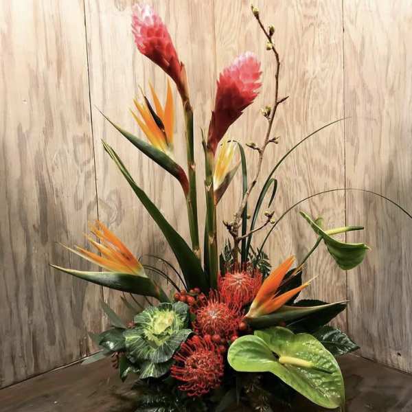 Tall tropical arrangement with bird of paradise, red protea, and anthurium