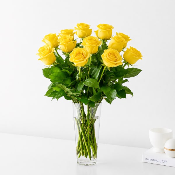 Yellow roses arranged in a clear glass vase