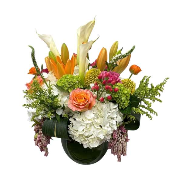 Colorful floral arrangement in a dark glass vase with lilies and roses