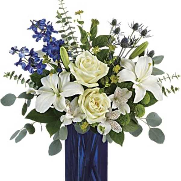 White lilies and roses in a blue glass vase