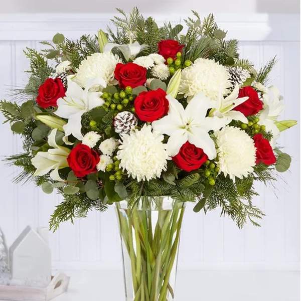 Red roses and white lilies in a clear glass vase