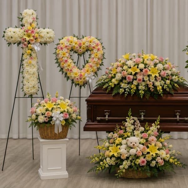 Funeral casket surrounded by pastel floral sprays and wreaths