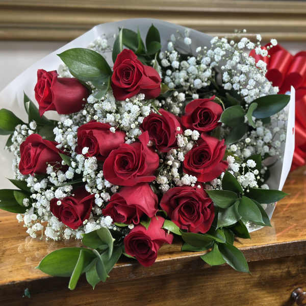Bouquet of red roses with white baby's breath and a red ribbon