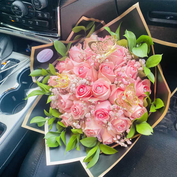 Pink rose bouquet with green leaves and gold butterfly picks