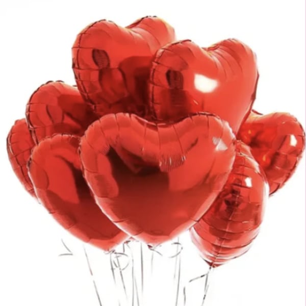 Cluster of red heart-shaped balloons on thin strings
