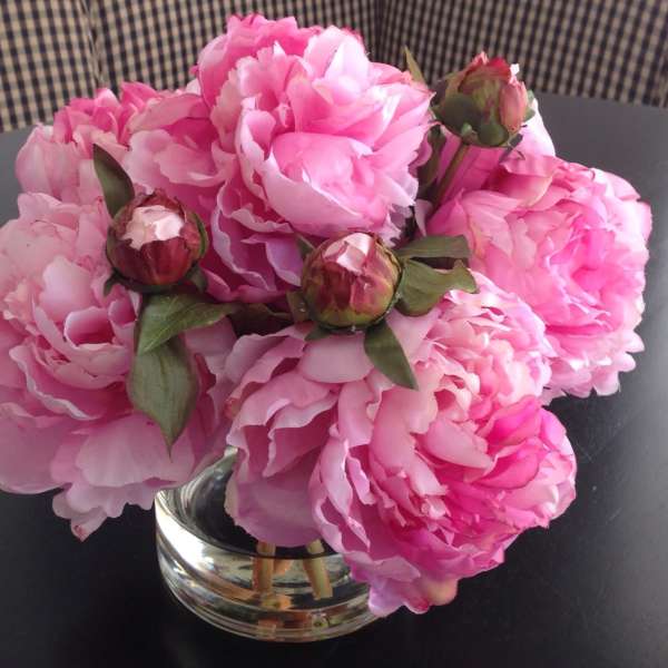 Pink peonies arranged in a clear glass vase