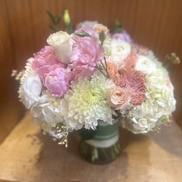 Bouquet of pink, white, and peach flowers in a glass vase