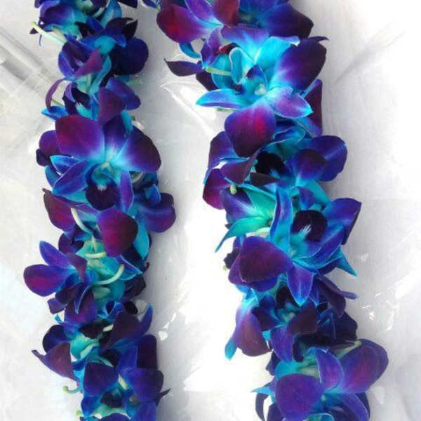 Purple and blue flower lei on white fabric