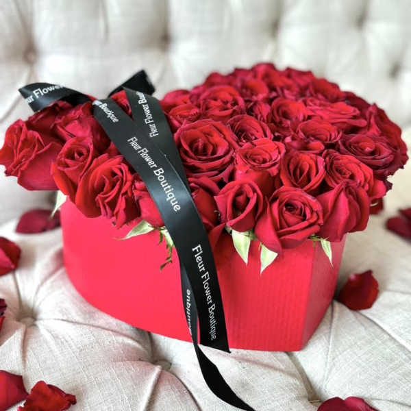 Heart-shaped box of red roses with black ribbon
