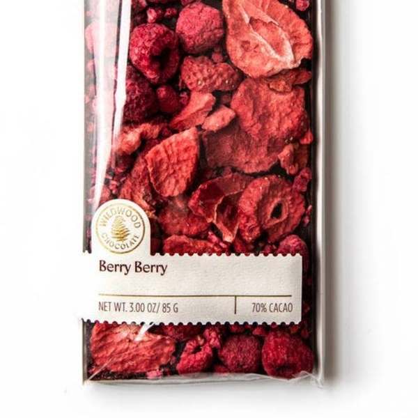 Wrapped chocolate bar topped with dried red berry pieces