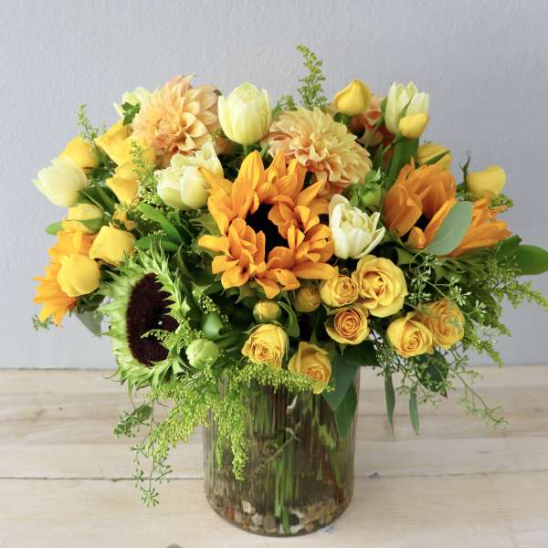 Yellow and orange mixed bouquet in a glass vase