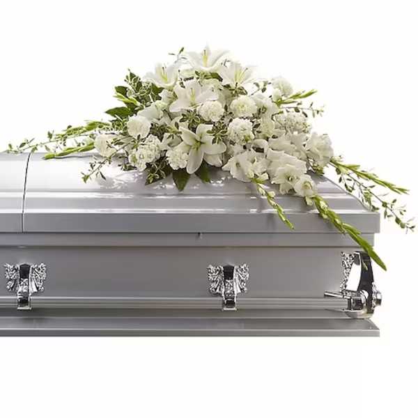 White floral spray on a silver casket