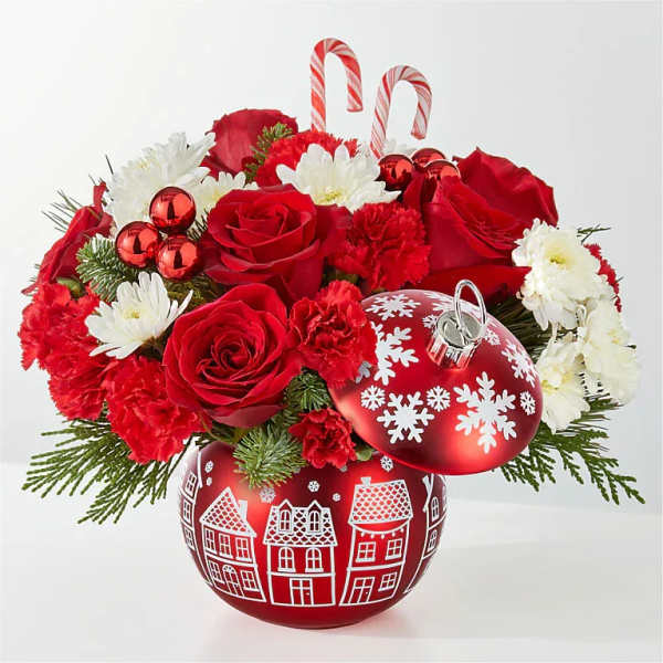 Red roses and white daisies with candy cane picks in a holiday ornament container