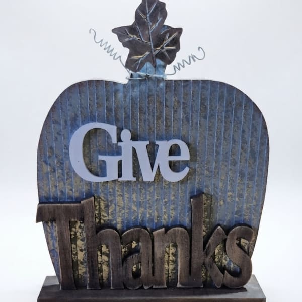 Decorative tabletop sign shaped like a pumpkin with the words Give Thanks
