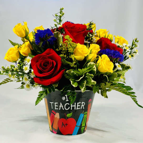 Bouquet of red and yellow roses in a teacher-themed container